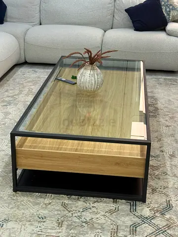 Modern glass-top coffee table with oak drawer and black metal frame