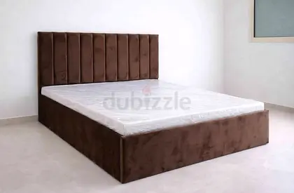 Brown upholstered king size bed with padded headboard - good quality