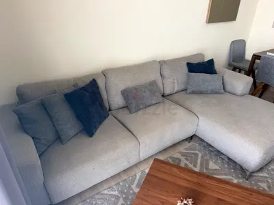Light grey L-shaped fabric sofa with chaise