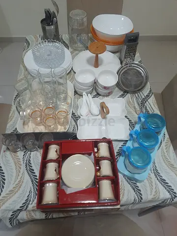 Mixed kitchenware set — plates, glasses, mugs, cutlery and serving pieces
