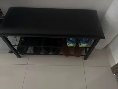 Black faux leather shoe bench with metal frame and storage