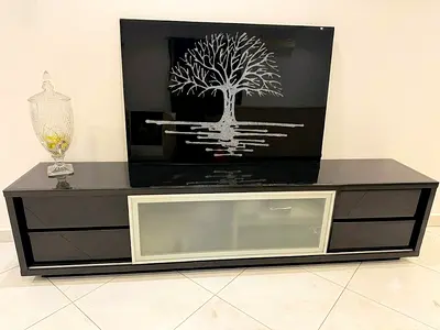 Black glossy low TV cabinet with frosted glass center - modern design