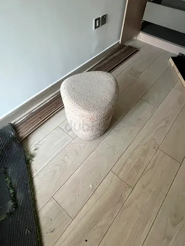 Small beige boucle pouf/ottoman - cozy floor seat, very dusty