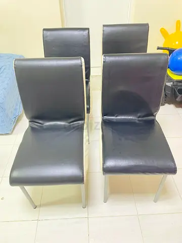 Set of 4 black faux leather dining chairs with metal legs - used