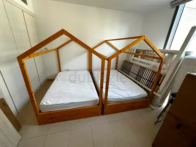 Pair of wooden house-frame kids beds with storage drawers