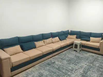 Large L-shaped sectional sofa in beige and blue - good condition