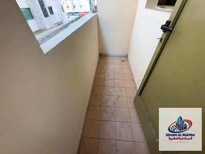 1BR apartment in Al Shahin with balcony and central gas, prime location close to all services, annual rent AED 24,000.