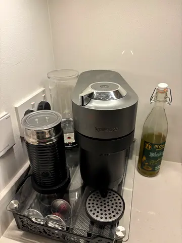 Nespresso OriginalLine Coffee Machine with Aeroccino Milk Frother and glass pod holder.