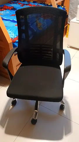 Black ergonomic mesh office chair with armrests and wheels