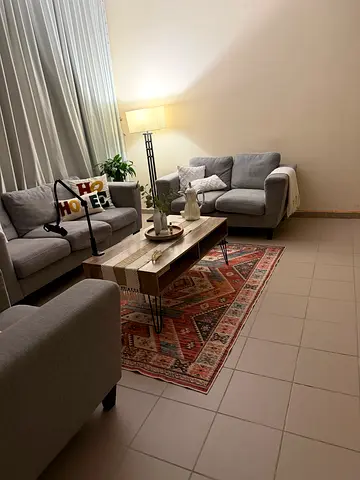 Light grey 3-seater sofa set with ottoman and patterned rug