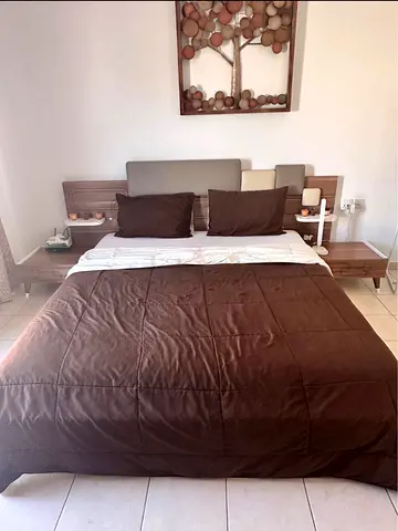 King bed frame with headboard and matching bedside tables and mattress - wood finish