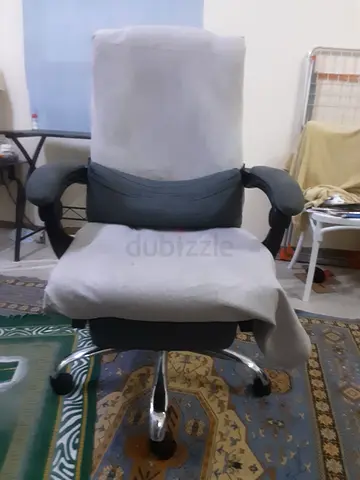 Used ergonomic office swivel chair with armrests and caster wheels