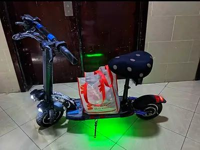 Used Electric Scooter with Seat and Green LED Lights - Good Condition