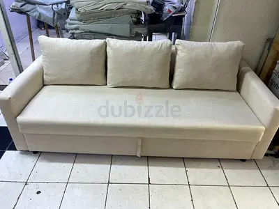 Beige three-seater sofa with storage - good condition