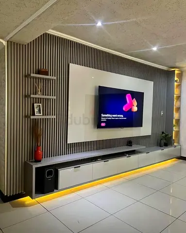 Modern wall-mounted entertainment unit with LED lighting and TV panel