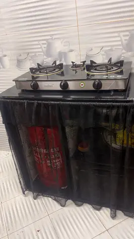 3-burner Glass Gas Stove Top with cylinder storage desk.