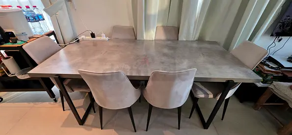 Modern concrete-look dining table with 6 upholstered chairs 1,000AED (negotiable)