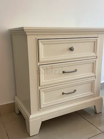 Cream wooden bedside nightstand with three drawers