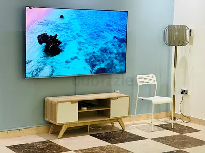 75-inch Q LED TV wall-mounted with TV cabinet, barely used