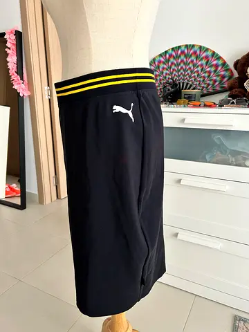 Black athletic skirt PUMA with yellow-striped waistband and cat logo - size M