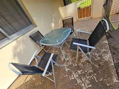 Glass-top Outdoor Patio Table with Metal Frame - Good Condition