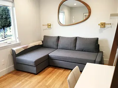 Gray L-shaped Sofa bed with Chaise — Compact, Good Condition