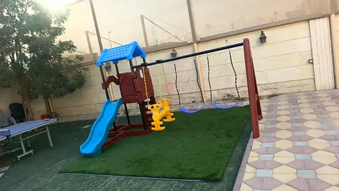Outdoor wooden playset with slide, swings and toddler seat - good condition