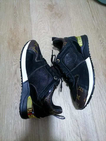 Black designer-style casual sneakers with gold heel detail, size 38.5