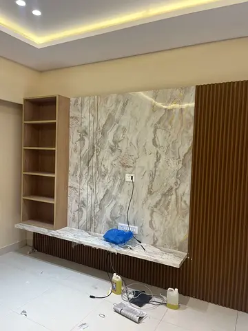 Modern marble-look TV entertainment wall panel with shelving