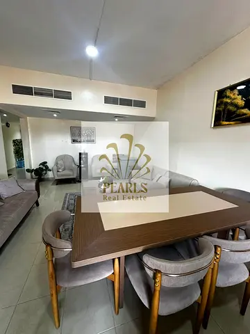 Furnished 2BR in Horizon Towers with open-view balcony, free parking, spacious layout, close to Ajman Corniche and all services.
