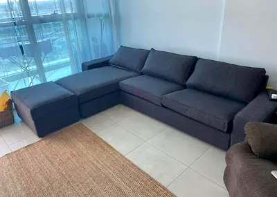 Dark grey L-shaped 4-seater sofa with ottoman -