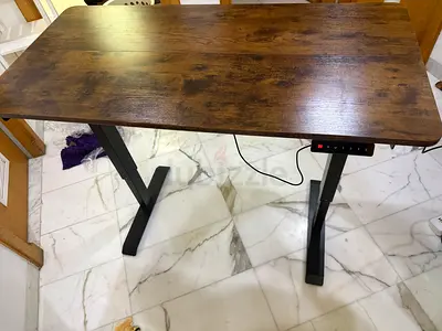 Height-adjustable standing desk with wood finish top