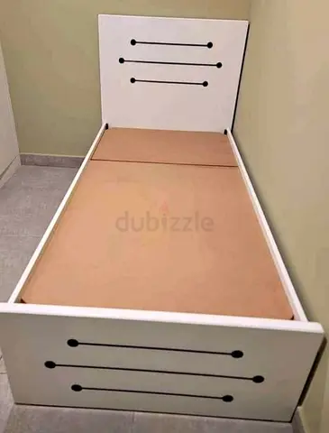 Single white wooden bed frame with headboard and footboard