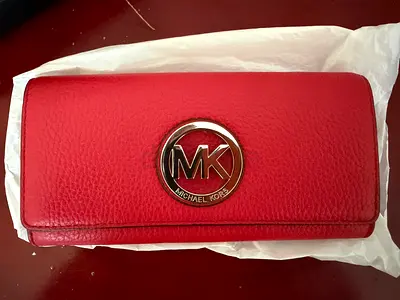 Red Michael Kors leather wallet with MK logo - New original price 600 AED.