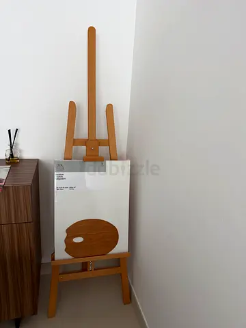 Wooden studio easel with artist palette canvas