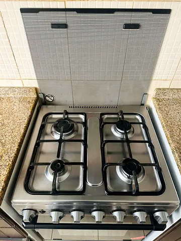Used 4-Burner Stainless Steel Gas Stove with unused Oven with the accessories .
