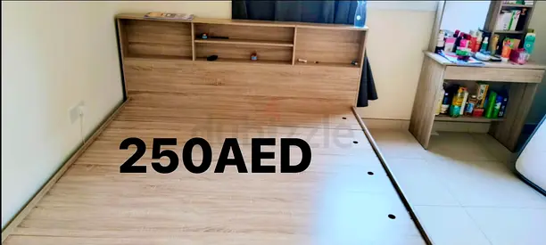 Wooden bed frame with headboard storage — good condition, 250 AED