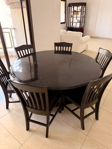 Solid dark round dining table with 6 matching chairs
