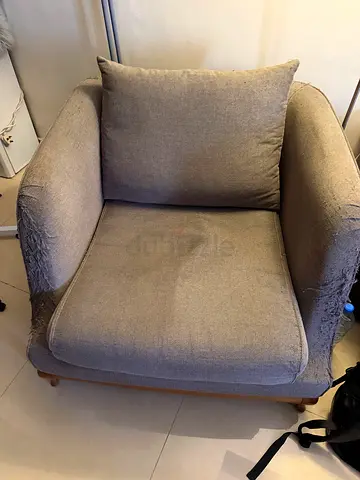 Single beige upholstered armchair with cushions - used