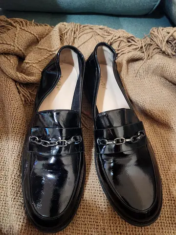 Black patent leather women's loafers with silver chain detail - size unknown
