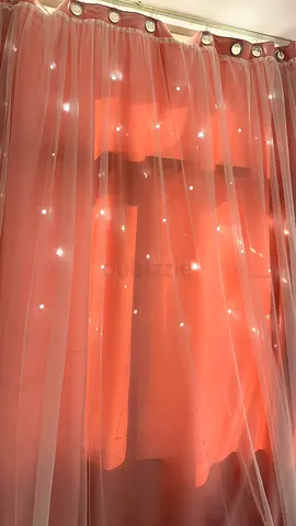 Pair of peach pink starry sheer curtains with blackout inner panels