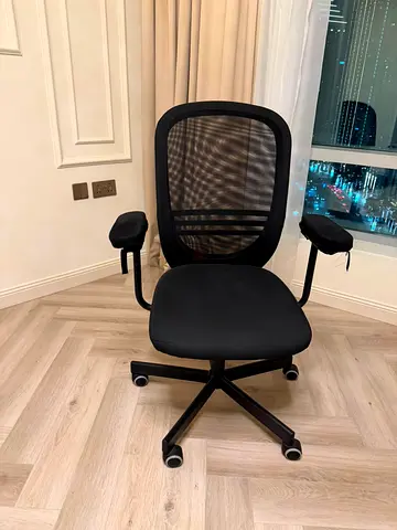 Black ergonomic mesh office chair with adjustable arms
