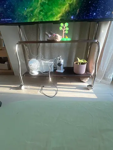 Small two-tier bedside/side table on wheels - brown metal frame