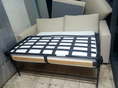 Beige 2-seater sofa with pull-out metal bed frame (folding guest bed)