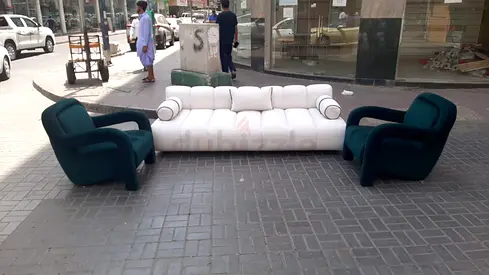 Low-profile white tufted sofa with two green lounge chairs - good condition