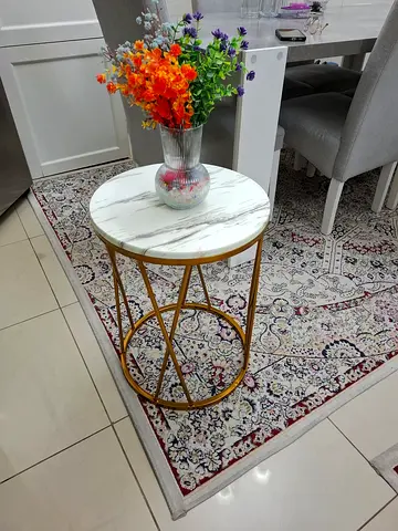 Small decorative round side table with faux marble top and gold frame