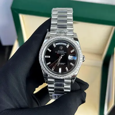 This is a Rolex Day-Date 40 in 18 ct white gold, featuring a black dial and a