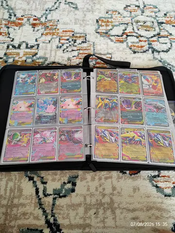 Collection of Pokémon Trading Cards in Binder - Various ultra rare + top loaders and sleeves