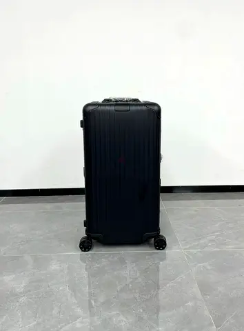 Rimova trunk plus black luggage