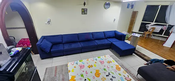 Large L-shaped navy blue fabric sectional sofa with chaise
